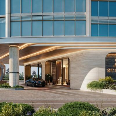 Entrance of the St. Regis-branded condo in Texas, showcasing a luxurious arrival area with modern architectural elements and lush landscaping.